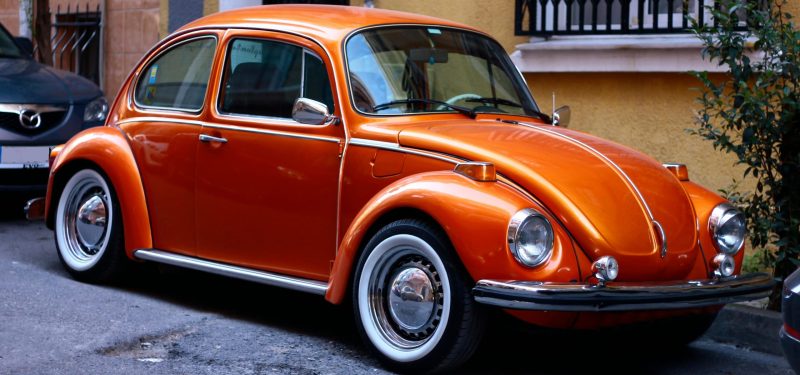 A classic orange Volkswagen Beetle parked on a street in Istanbul.