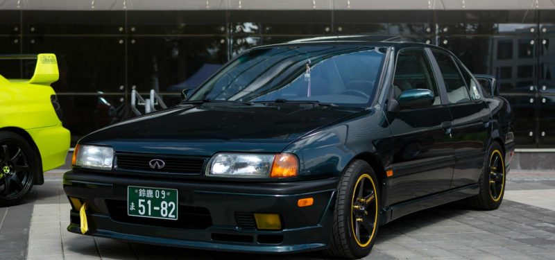 A black Infiniti car parked in an urban setting in Minsk, Belarus, showcasing its sleek design.