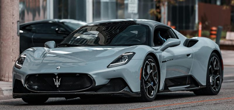 Elegant Maserati MC20 supercar parked on an urban street, showcasing modern luxury.