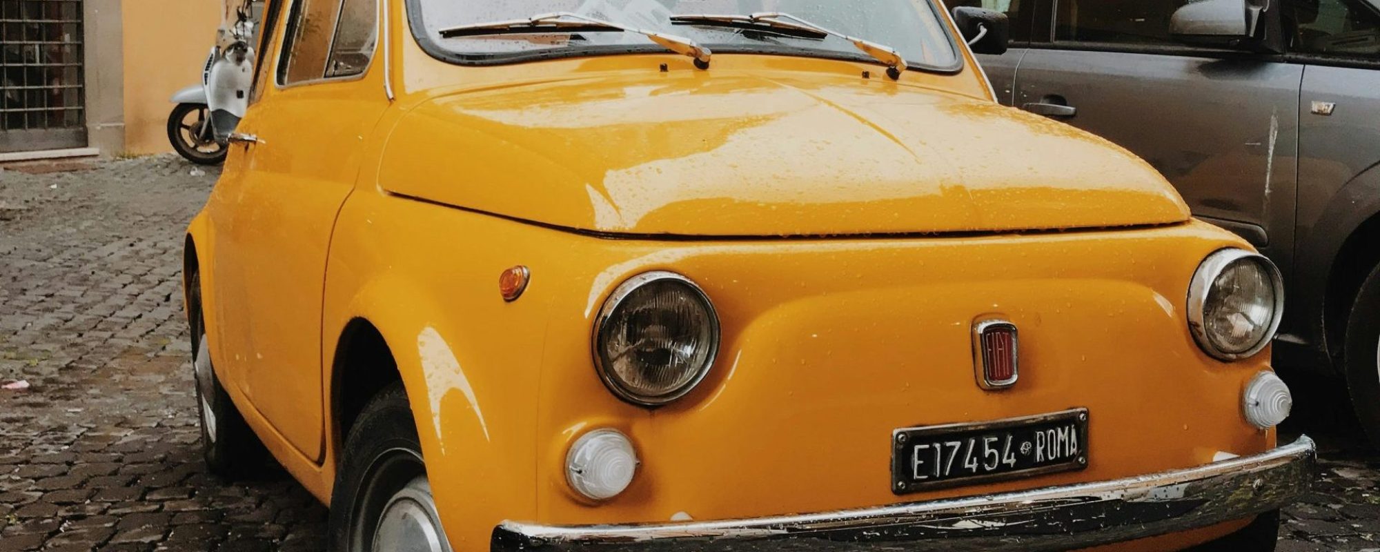 Classic yellow Fiat 500 on a cobblestone street in Rome, Italy, by Mark Neal. Fiat Wheel Spacers