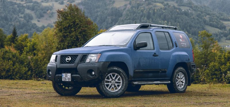A rugged blue Nissan SUV parked by Tomas Malik via pexels. Nissan wheel spacers / adapters
