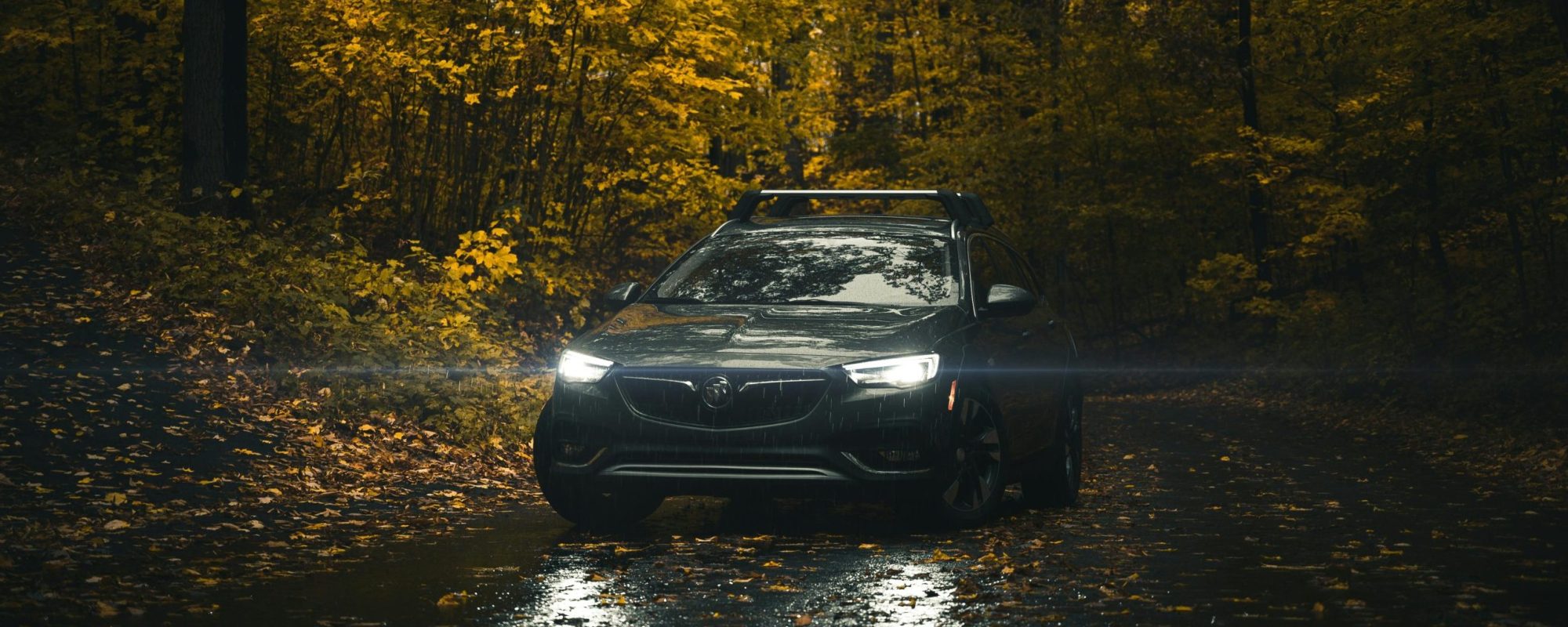 A Buick SUV with driving through a scenic autumn forest road. Buick Wheel Spacers & Adapters