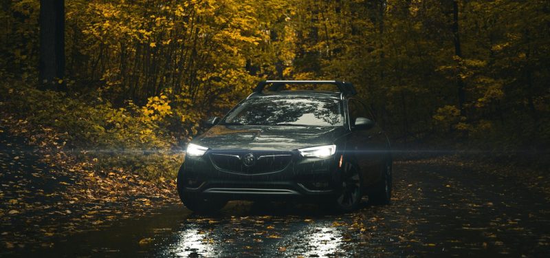 A Buick SUV with driving through a scenic autumn forest road. Buick Wheel Spacers & Adapters