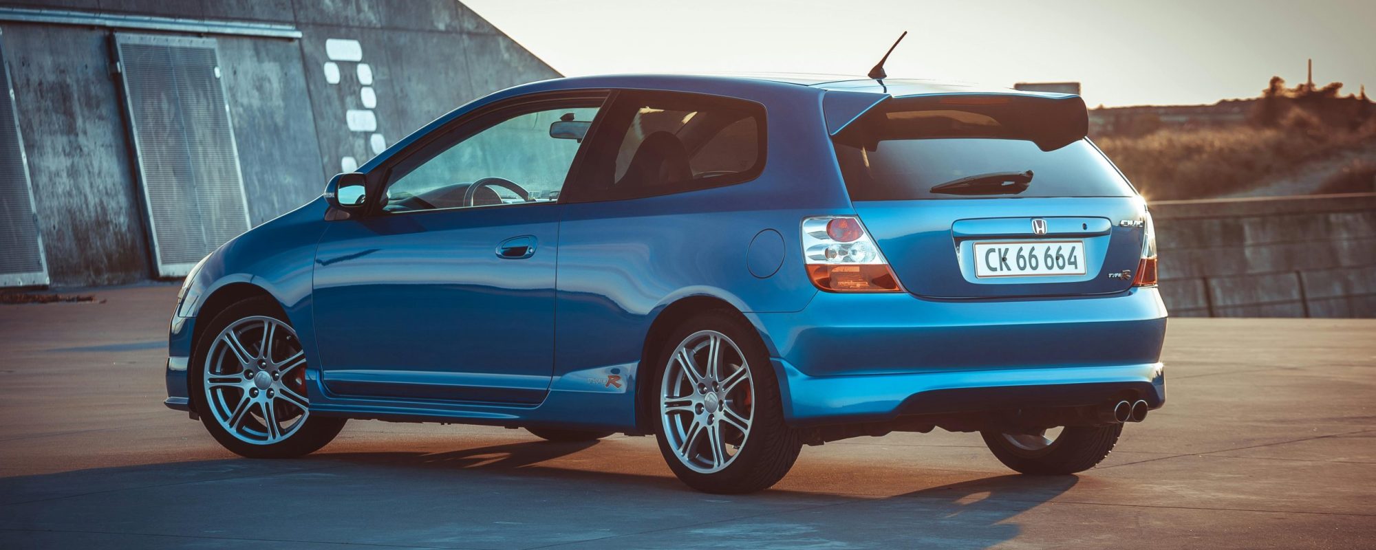 Stylish blue hatchback parked outdoors in Denmark, showcasing modern design.