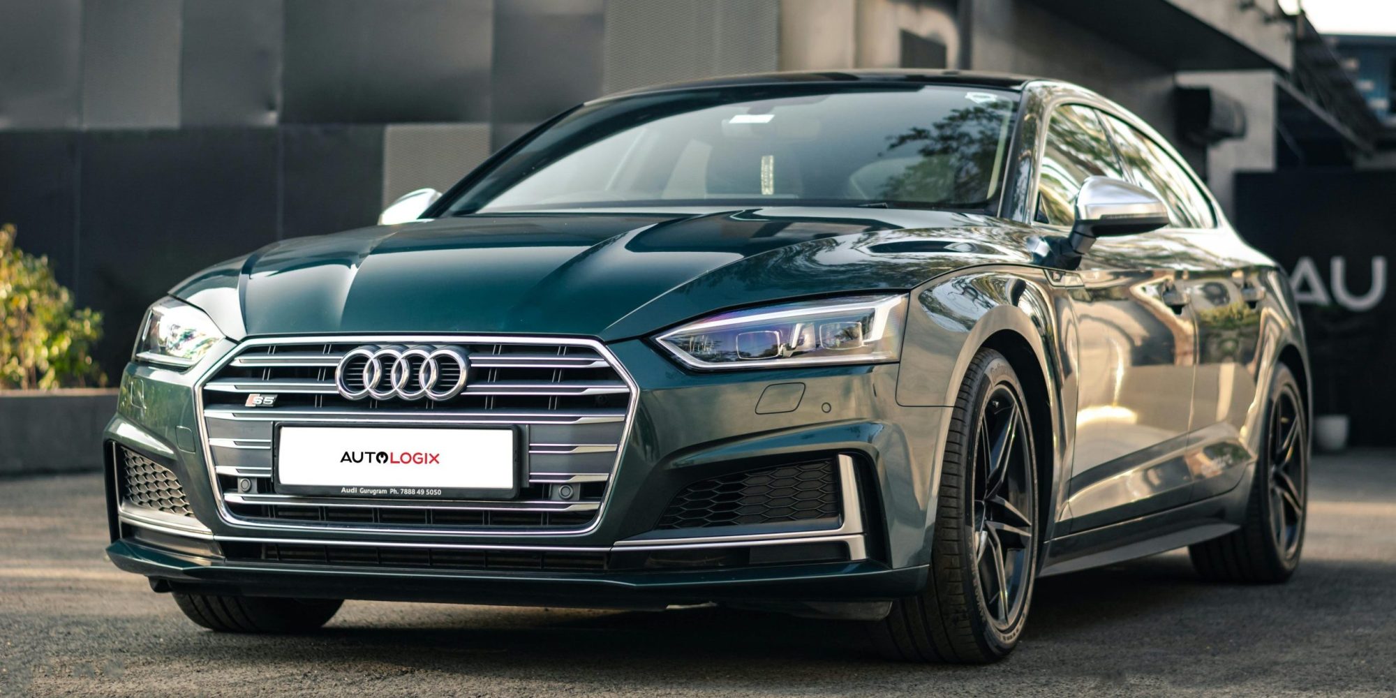 Sleek black Audi S5 sports car parked outdoors showcasing its modern design and luxury features.